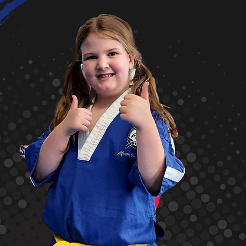 Ninja Kids child, girl age 7-12 wearing blue Kane Academy uniform